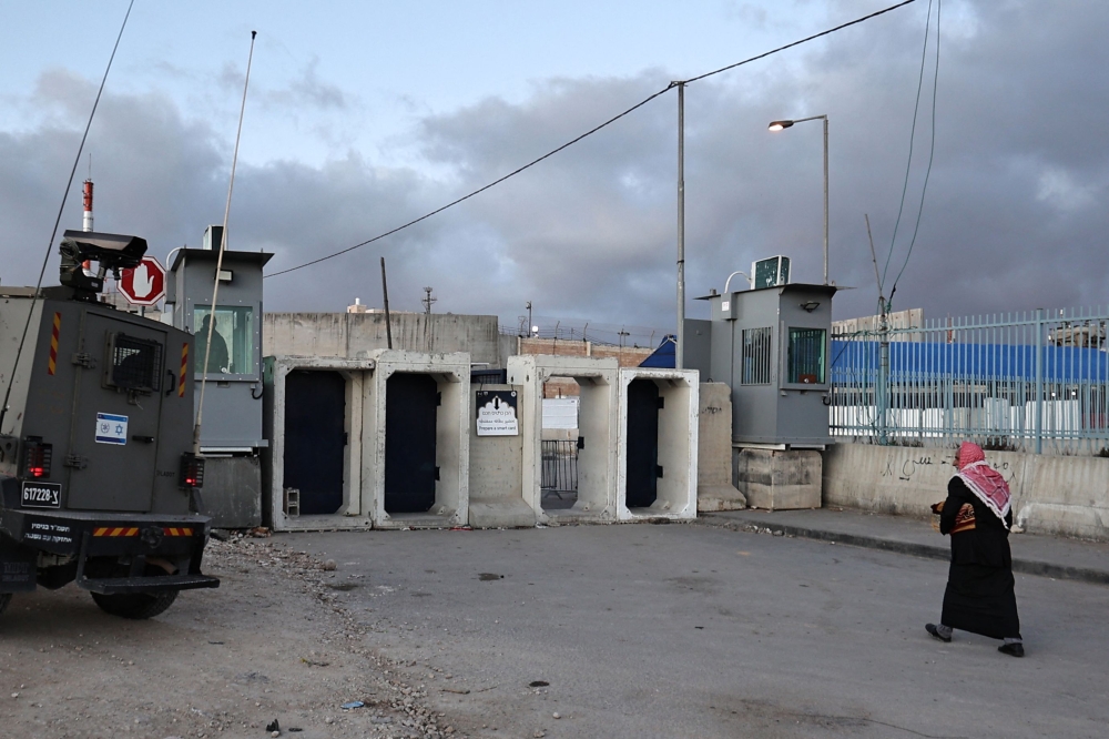 An elderly Palestinian Muslim man arrives to cross an Israeli checkpoint in Qalandia, in the occupied West Bank, on March 22, 2024, as worshippers head to Jerusalem to attend the second Friday Noon prayer of Islam's holy fasting month of Ramadan at the Al Aqsa mosque compound. — AFP pic 