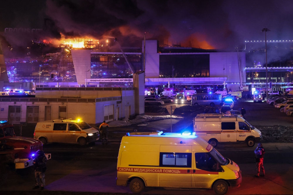 Emergency services vehicles are seen outside the burning Crocus City Hall concert hall following the shooting incident in Krasnogorsk, outside Moscow, on March 22, 2024. ― AFP pic