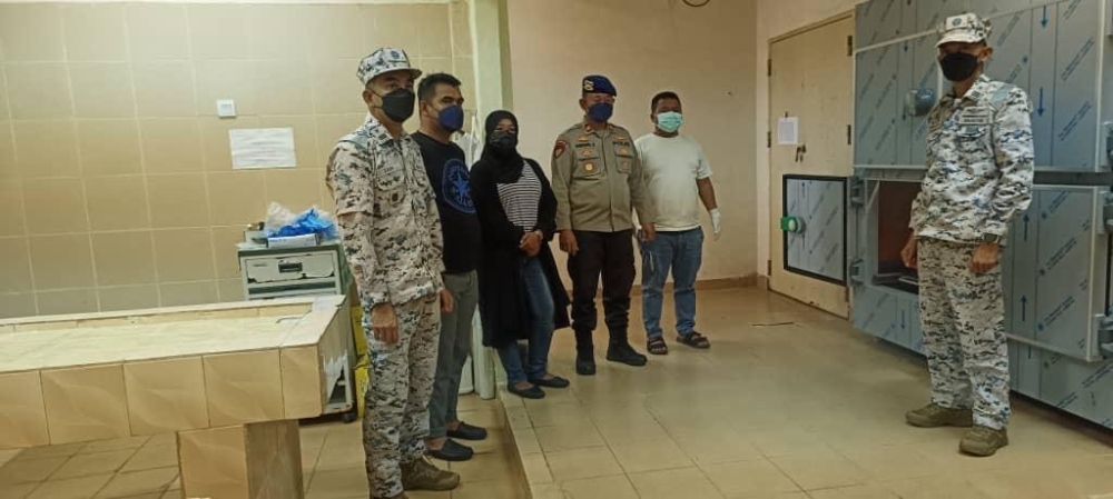 The Malaysian and Indonesian authorities with the missing fisherman Muhamad Sufian Alwi’s sister during the identification and confirmation process at the forensics department of the Raja Ahmad Tabib district general hospital in the Kepri-Tanjung Pinang province in Indonesia March 23, 2024. —Picture courtesy of Johor Malaysian Maritime Enforcement Agency (MMEA) 