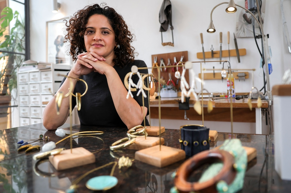Kenyan designer Ami Doshi Shah, with some of her eclectic jewelry pieces at her home studio, where she creates eclectic hand-made jewelry using locally sourced raw materials varying among semi-precious stones and metals, in Nairobi on February 16, 2024. — AFP pic 