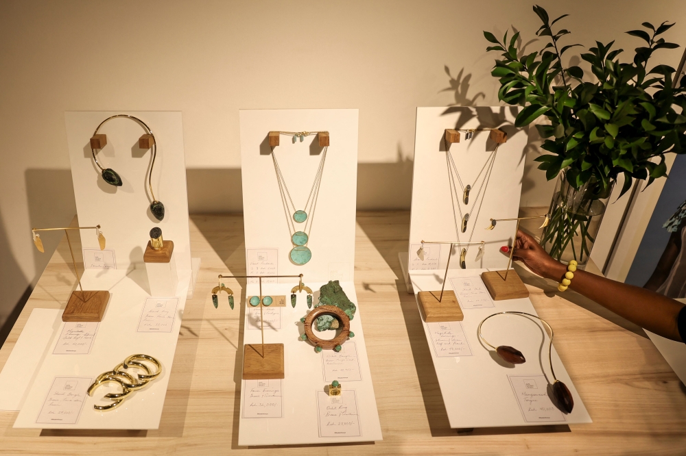 A staff member arranges a display of Kenyan designer Ami Doshi Shah's hand-crafted jewelry at a showcase of designs by several local artists, called Jamaa (swahili for community) fashion pop-up, in Nairobi on February 16, 2024. — AFP pic 