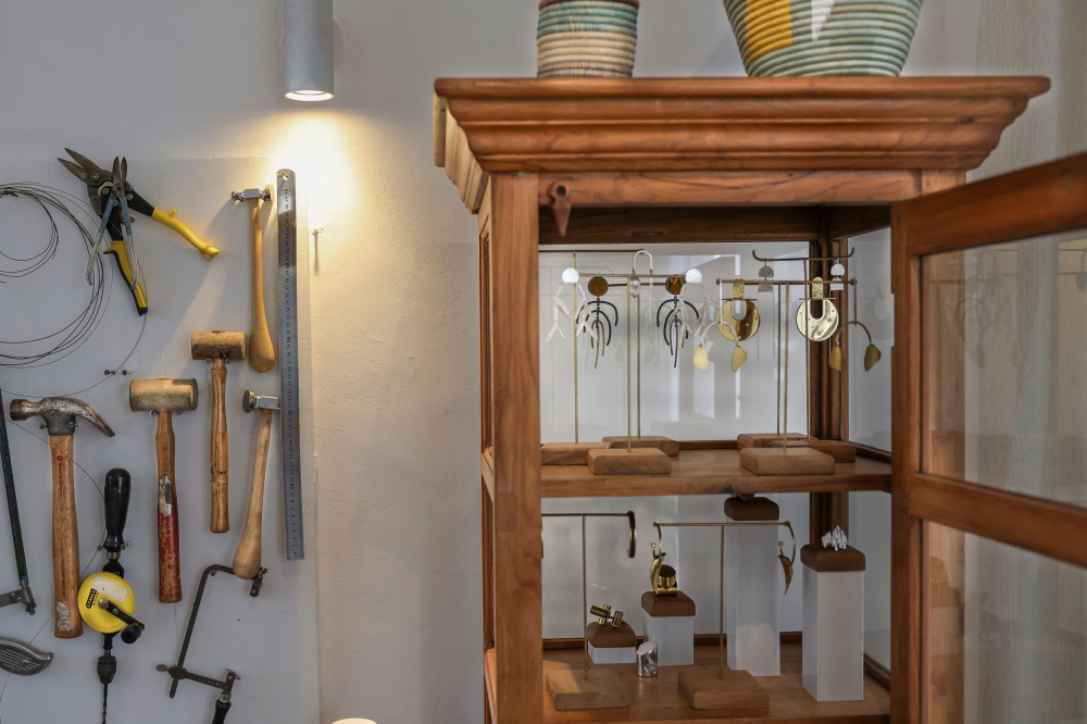 Kenyan designer Ami Doshi Shah, eclectic jewelry pieces are displayed in a cabinet at her home studio, where she creates hand-made jewelry using locally sourced raw materials varying among semi-precious stones and metals, in Nairobi on February 16, 2024. — AFP pic 