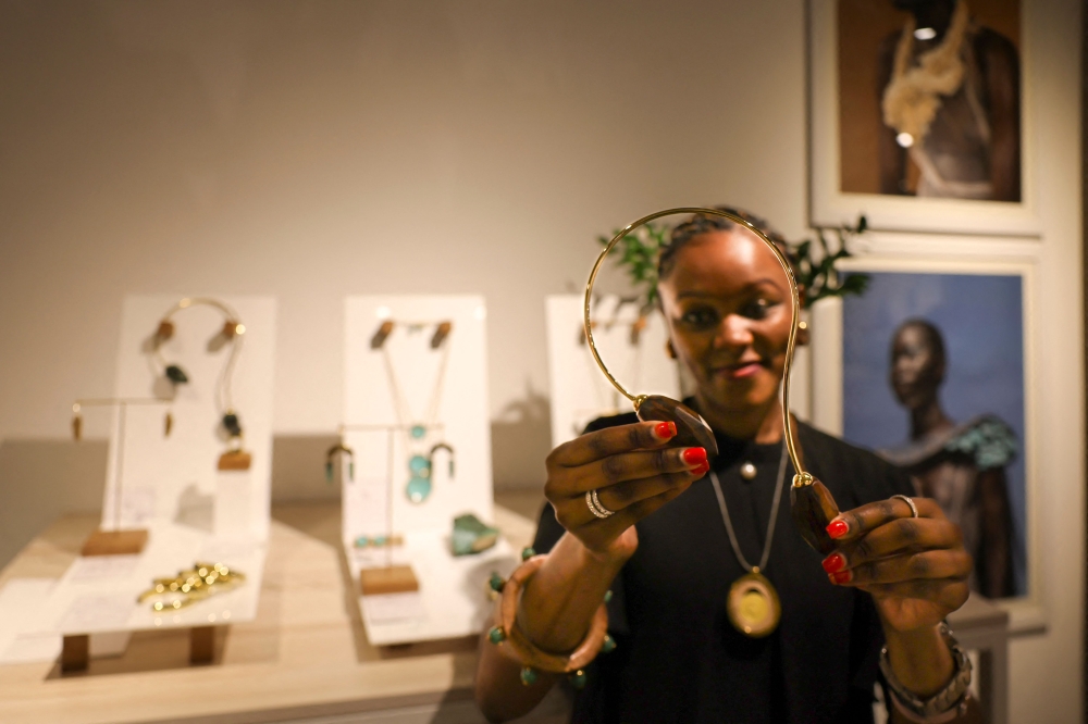 A staff member displays a neck piece jewelry from a display of Kenyan designer Ami Doshi Shah's hand-crafted designs at a showcase of creations by several local artists, called Jamaa (swahili for community) fashion pop-up, in Nairobi February 16, 2024. — AFP pic