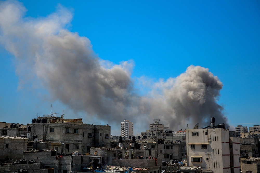 A picture shows smoke billowing after Israeli bombardment in the vicinity of the Al-Shifa hospital in Gaza City on March 21, 2024, amid ongoing battles between Israel and the militant group Hamas. — AFP pic
