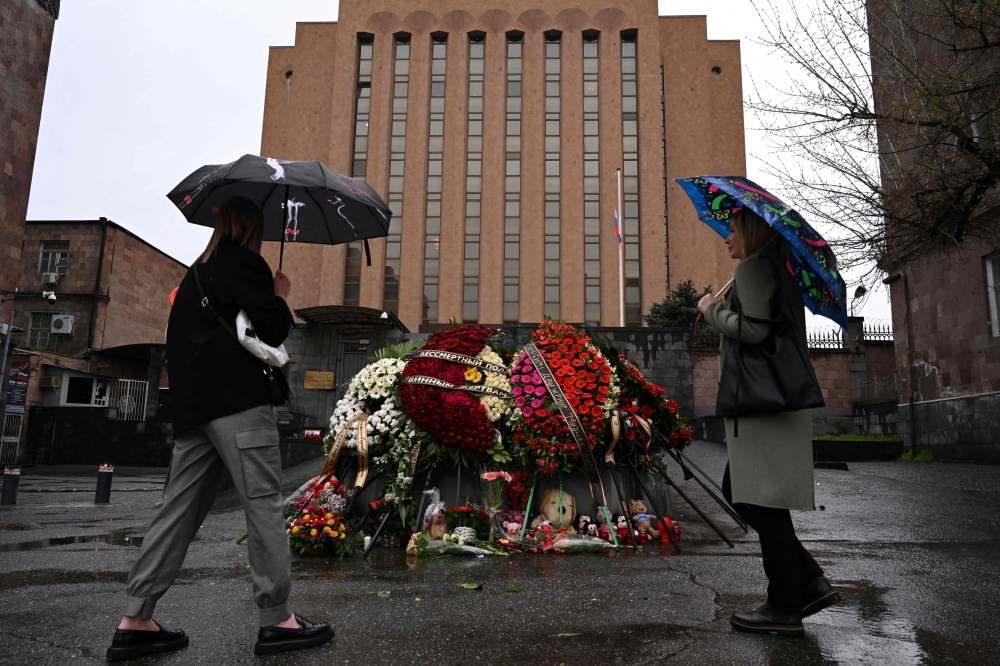 People mourn at a makeshift memorial in front of the Russian embassy in Yerevan on March 23, 2024, a day after a gun attack on the Crocus City Hall in Russia’s Krasnogorsk. — AFP pic