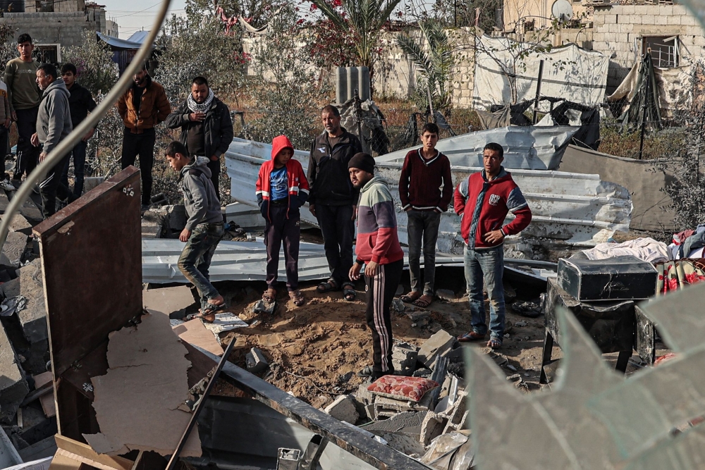 Palestinians assess the destruction of a house hit by Israeli bombardment in the northern part of Rafah in the southern Gaza Strip on March 23, 2024, amid ongoing battles between Israel and Hamas. — AFP pic