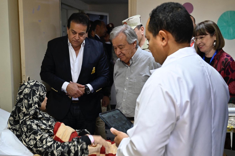 This handout pictured released by the United Nations press office shows UN Secretary-General Antonio Guterres meeting with a Palestinian woman evacuated from the Gaza Strip receiving treatment at the general hospital in El-Arish in Egypt’s north-eastern North Sinai province on March 23, 2024, amid the ongoing conflict in the Palestinian territory between Israel and the militant group Hamas. — AFP pic
