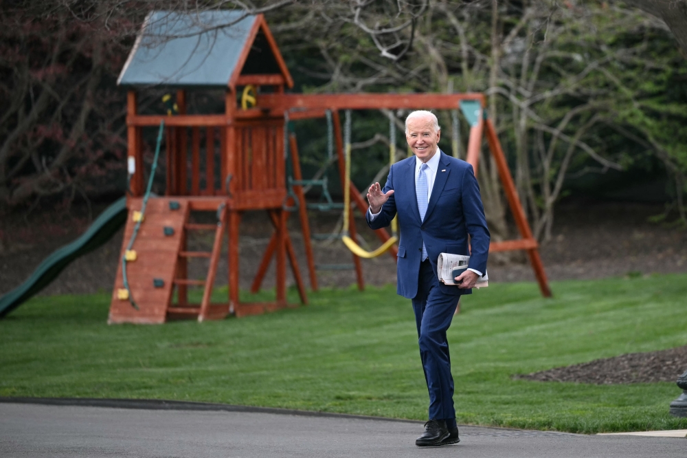 US President Joe Biden waves as he makes his way to board Marine One before departing from the South Lawn of the White House in Washington, DC, on March 22, 2024. Biden is heading to Wilmington, Delaware, for the weekend. — AFP pic