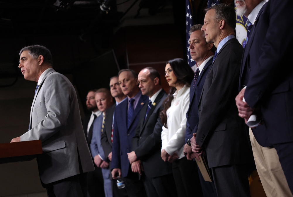 US Rep. Andrew Clyde (right) speaks alongside fellow Freedom Caucus members during a press conference on the government funding bill at the US Capitol on March 22, 2024 in Washington, DC. — AFP pic