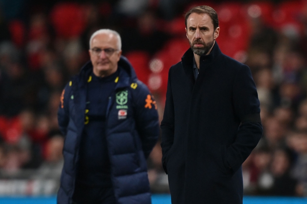 England’s manager Gareth Southgate (right) and Brazil’s head coach Dorival Junior (left) look on during the international friendly football match between England and Brazil at Wembley stadium in north London on March 23, 2024. — AFP pic