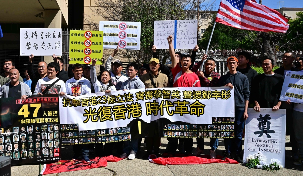People gather to protest against Hong Kong’s new national security law outside the Chinese embassy in Los Angeles on March 24, 2024. — AFP pic