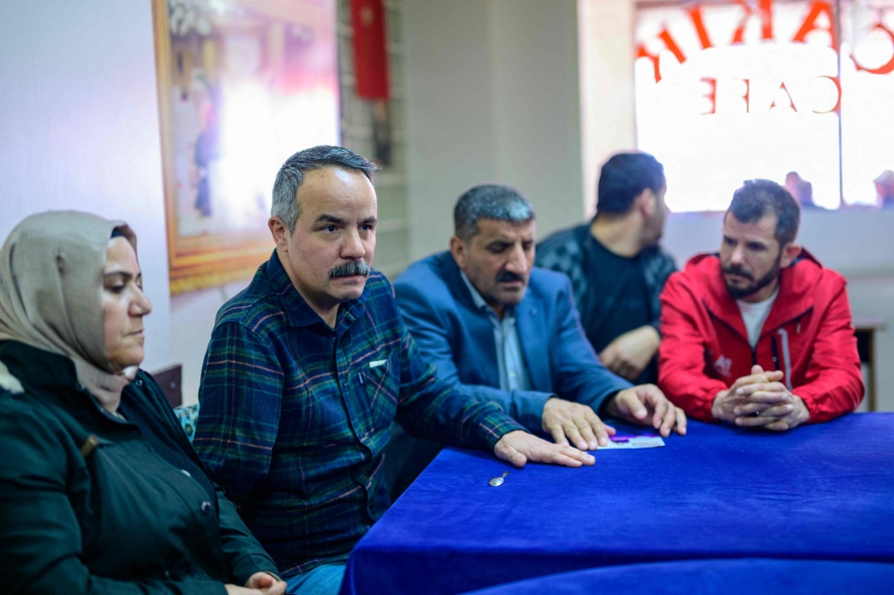 Candidate of the Peoples’ Equality and Democracy Party Veli Sacilik (second right) and his running mate Birsen Bas (left) meet local residents in Bolu, on March 4, 2024. — AFP pic
