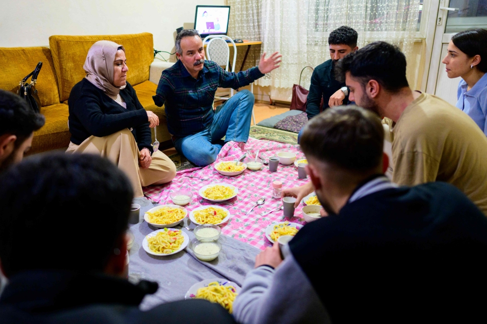 Candidate of the Peoples’ Equality and Democracy Party Veli Sacilik (centre) and his running mate Birsen Bas (left) meet local residents in Bolu, on March 4, 2024. — AFP pic
