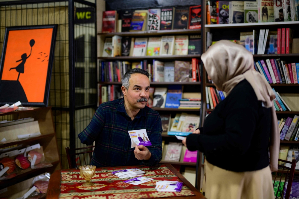 Candidate of the Peoples’ Equality and Democracy Party Veli Sacilik shows his campaign leaflets in Bolu, on March 4, 2024. — AFP pic