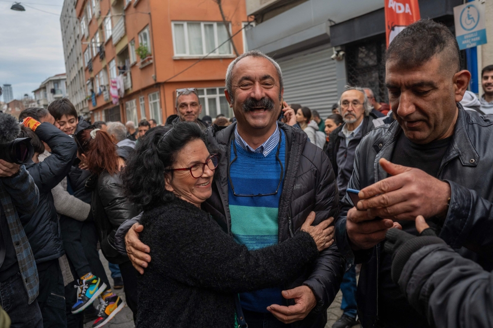 File photo of Mayor of Tunceli Fatih Mehmet Macouglu (centre) meeting his supporters at Kadikoy, in Istanbul during his campaign on February 11, 2024. — AFP pic