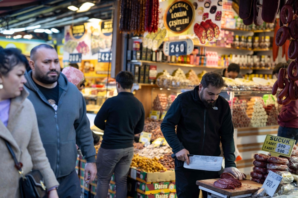 A vendor cuts bacon during of the holy month of Ramadan near Eminonu Square in Istanbul on March 15, 2024. — AFP pic