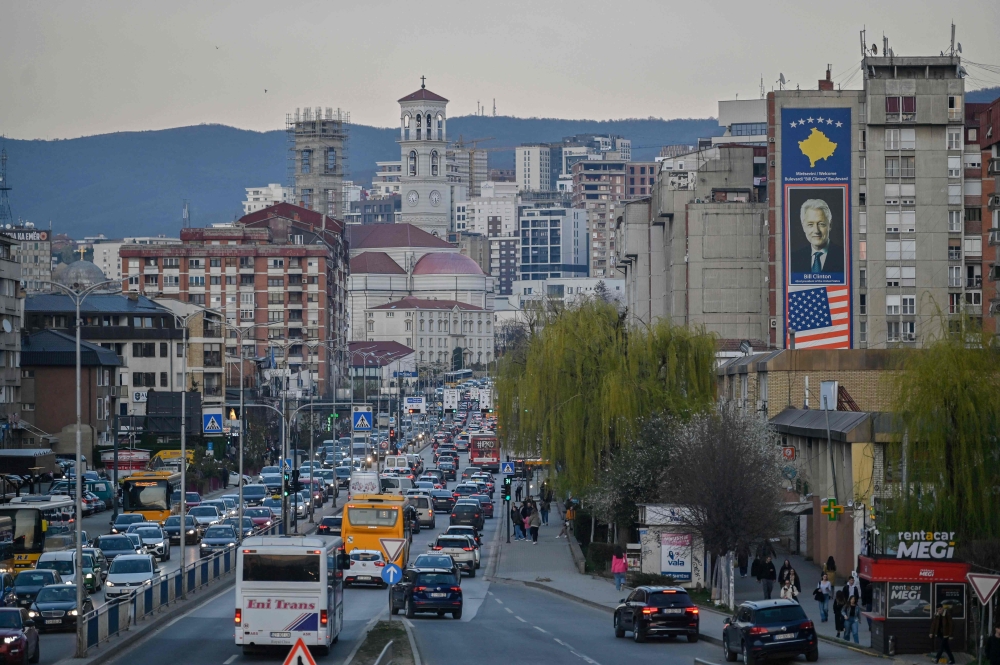 This photograph taken on March 22, 2024 shows a big banner depicting a portrait of former US president Bill Clinton in Pristina. — AFP pic