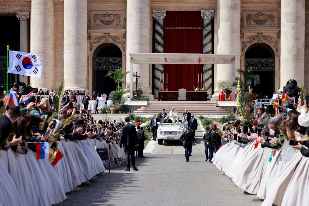 Pope Francis sits in a vehicle on the day of the Palm Sunday Mass in Saint Peter's Square at the Vatican, March 24, 2024. — Reuters pic