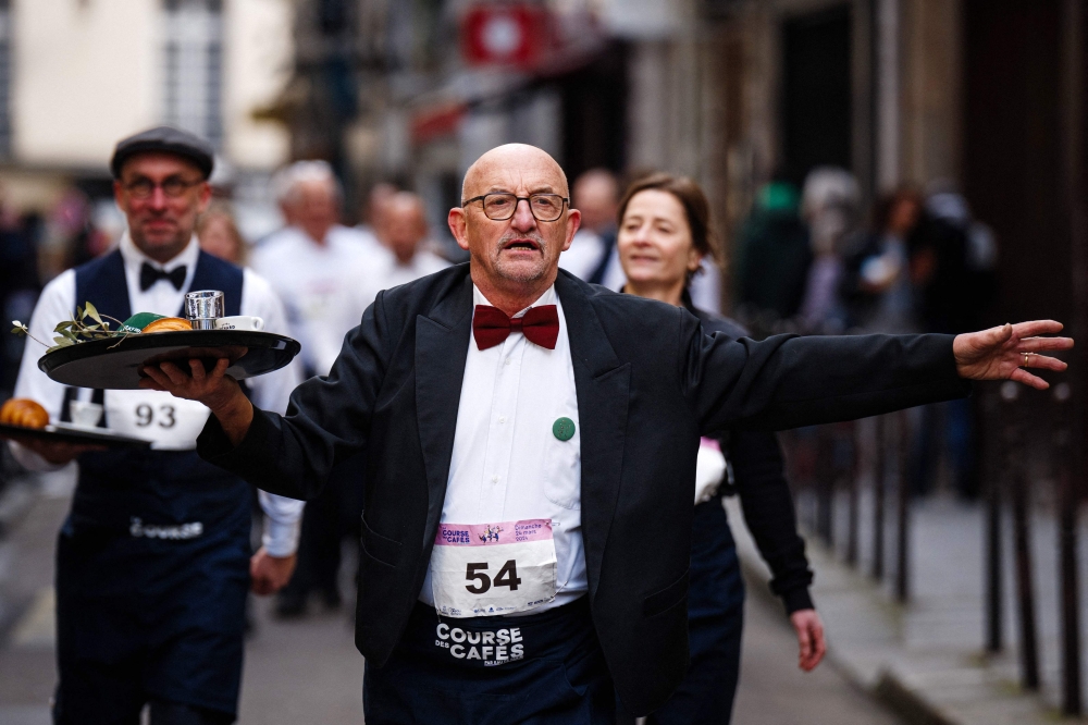 Waiters in work outfits compete in a traditionnal 