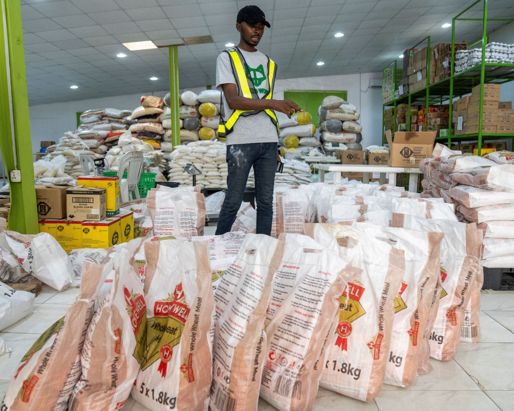 A volunteer counts stock of food items in the Lagos Food Bank warehouse in Lagos, Nigeria, March 23, 2024. — Reuters pic