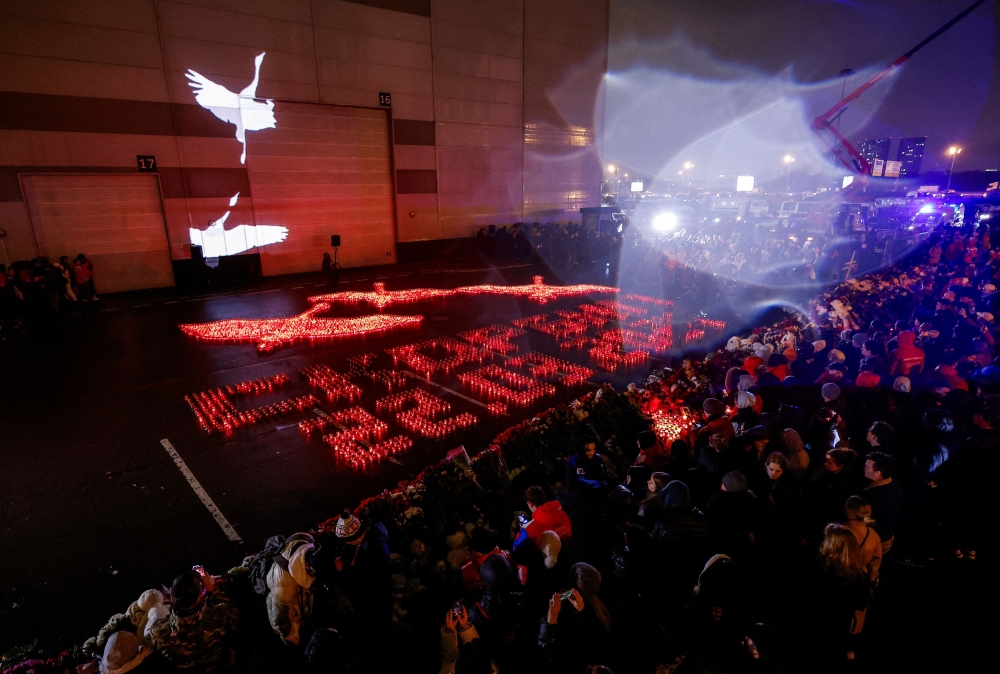 Lit candles forming the words ‘We mourn. 22.03.2024’ are placed outside the Crocus City Hall concert venue on the day of mourning declared following a deadly shooting, in the Moscow Region, Russia, March 24, 2024. — Reuters pic