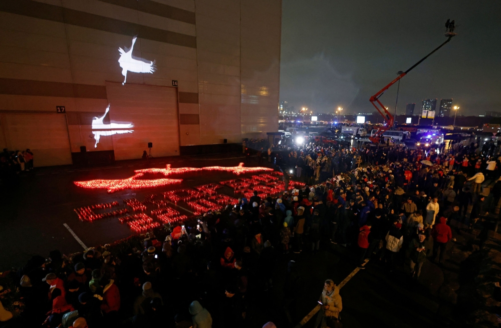 Lit candles forming the words ‘We mourn. 22.03.2024’ are placed outside the Crocus City Hall concert venue on the day of mourning declared following a deadly shooting, in the Moscow Region, Russia, March 24, 2024. — Reuters pic