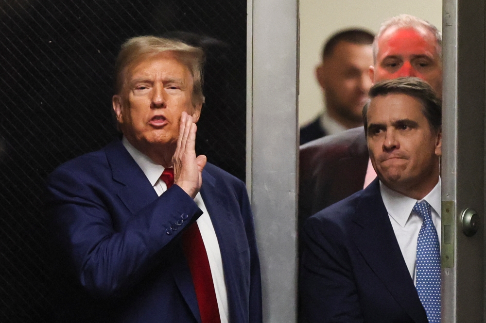 Donald Trump will in three weeks become the first former US president to face a criminal trial, a judge ruled yesterday, hours after an appeals court threw the tycoon a lifeline in his bid to stave off an unrelated, half billion dollar civil fraud judgment. — AFP pic