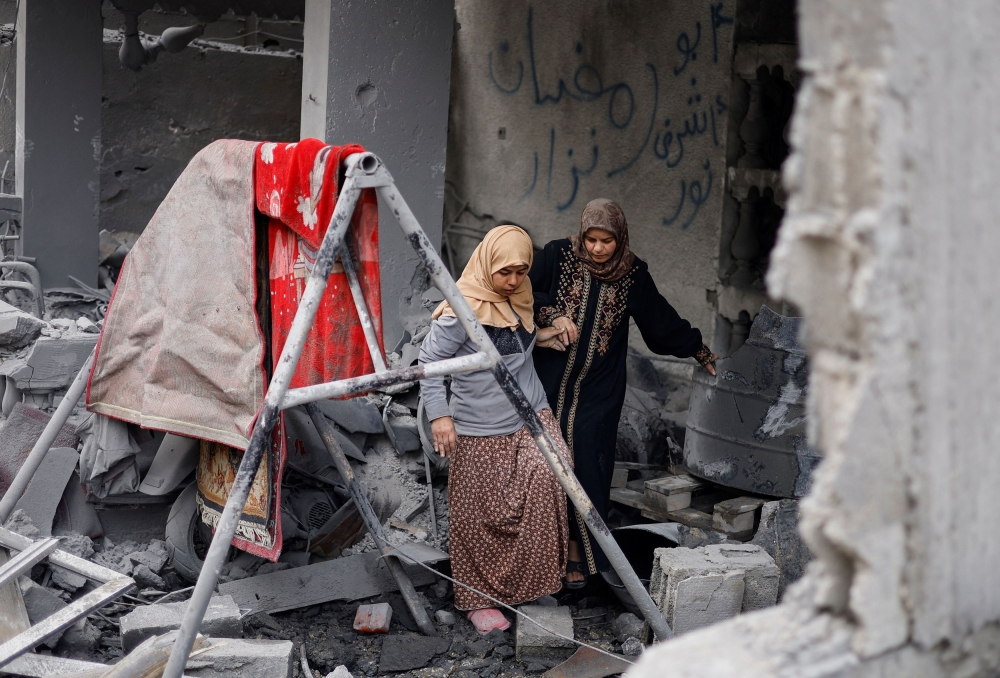 Palestinians inspect the site of an Israeli strike on a house, amid the ongoing conflict between Israel and Hamas, in Rafah, in the southern Gaza Strip, March 24, 2024. — Reuters pic
