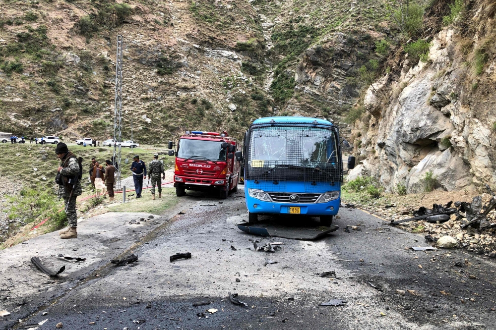 Security personnel inspect the site of a suicide attack near Besham city in the Shangla district of Khyber Pakhtunkhwa province on March 26, 2024. — AFP pic