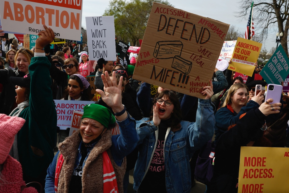 A demonstrator for abortion rights holds a sign during a protest outside the U.S. Supreme Court as justices hear oral arguments in a bid by President Joe Biden's administration to preserve broad access to the abortion pill, in Washington March 26, 2024. — Reuters pic