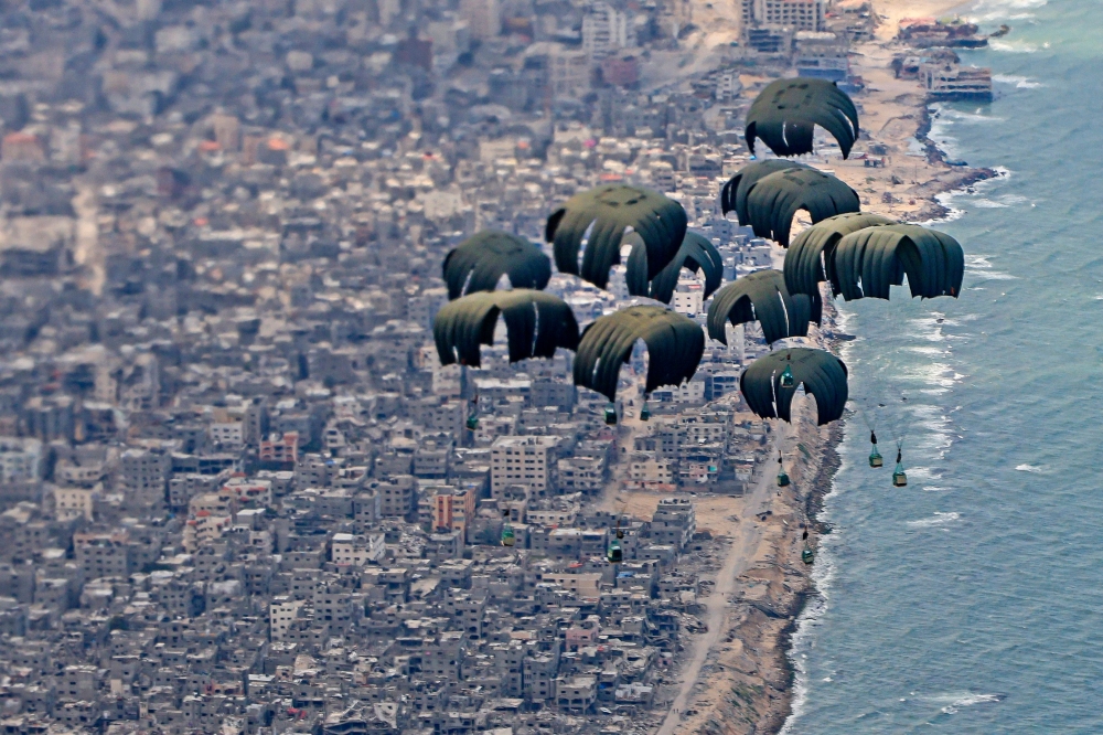 A handout picture taken and released by the British Ministry of Defence (MOD) on March 25, 2024 shows humanitarian aid being airdropped over Gaza from a RAF A400M aircraft. — AFP pic/Crown Copyright 2024/MOD/AS1 Leah Jones/RAF