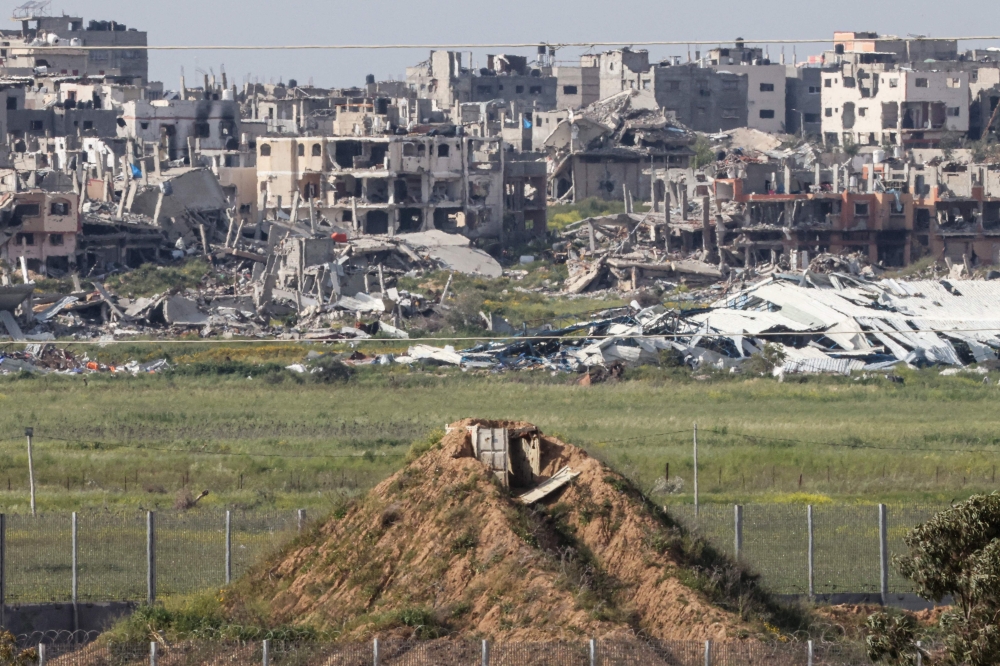This picture taken from Israel’s southern border with the Gaza Strip shows destroyed buildings in Gaza and an observation point. — AFP pic