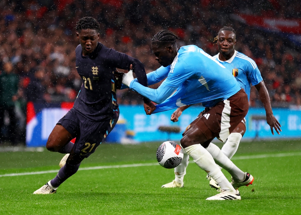 England's Kobbie Mainoo in action with Belgium's Amadou Onana and Jeremy Doku, March 27, 2024. ― Action Images via Reuters/Matthew Childs