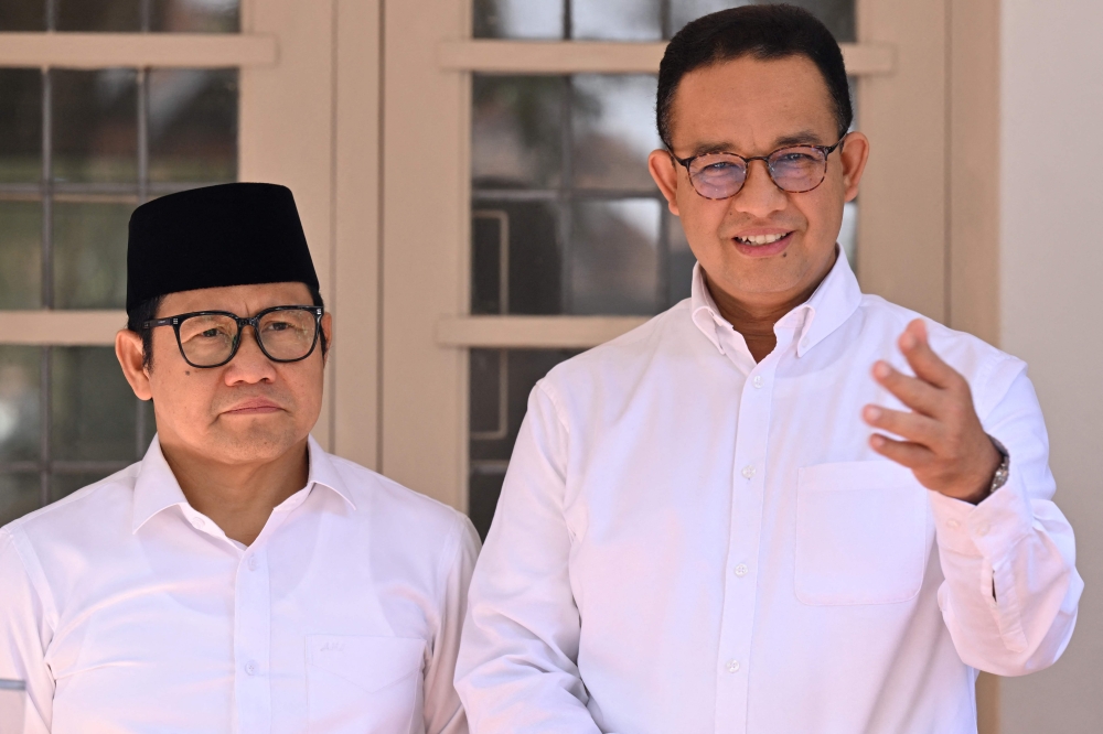 Indonesian presidential candidate Anies Baswedan (right) and his vice presidential running mate Muhaimin Iskandar hold a press conference in Jakarta on March 21, 2024, after the election commission announced Prabowo Subianto the winner of the February 2024 presidential election. — AFP pic