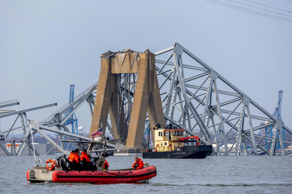Search divers were expected to return today to the waters surrounding the twisted ruins of a bridge knocked down in Baltimore Harbour by a faltering cargo ship, leaving six workers missing and presumed dead. — AFP pic