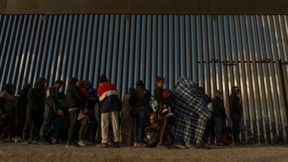 A drone view shows migrants as they line up against the border wall to surrender to immigration officials after breaching a razor wire-laden fence along the bank of the Rio Grande River in El Paso, Texas March 25, 2024. — Reuters pic