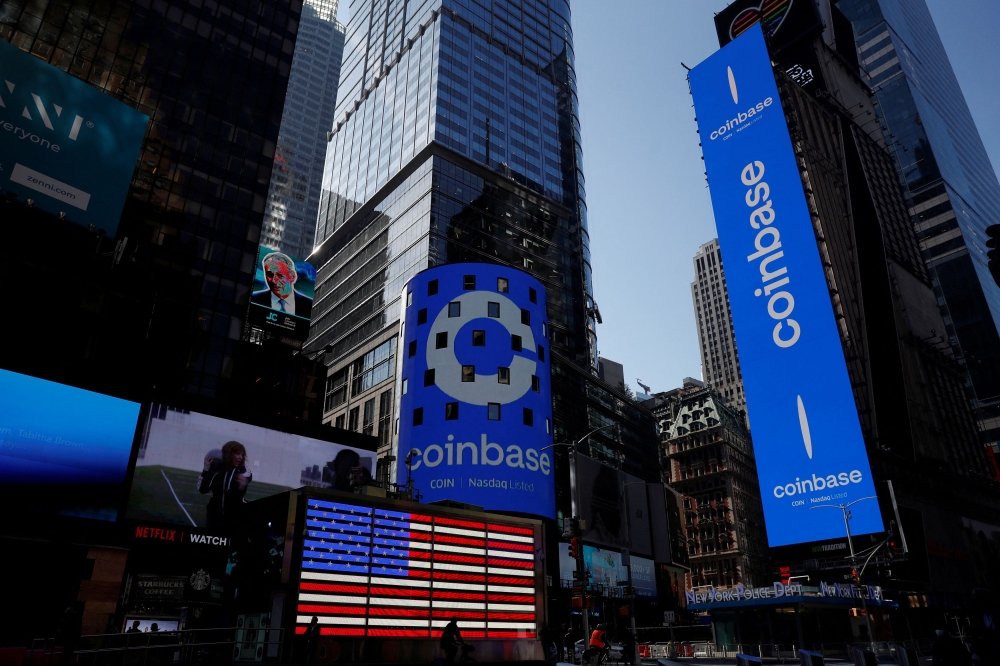 The logo for Coinbase Global Inc, the biggest US cryptocurrency exchange, is displayed on the Nasdaq MarketSite jumbotron and others at Times Square in New York April 14, 2021. — Reuters pic  
