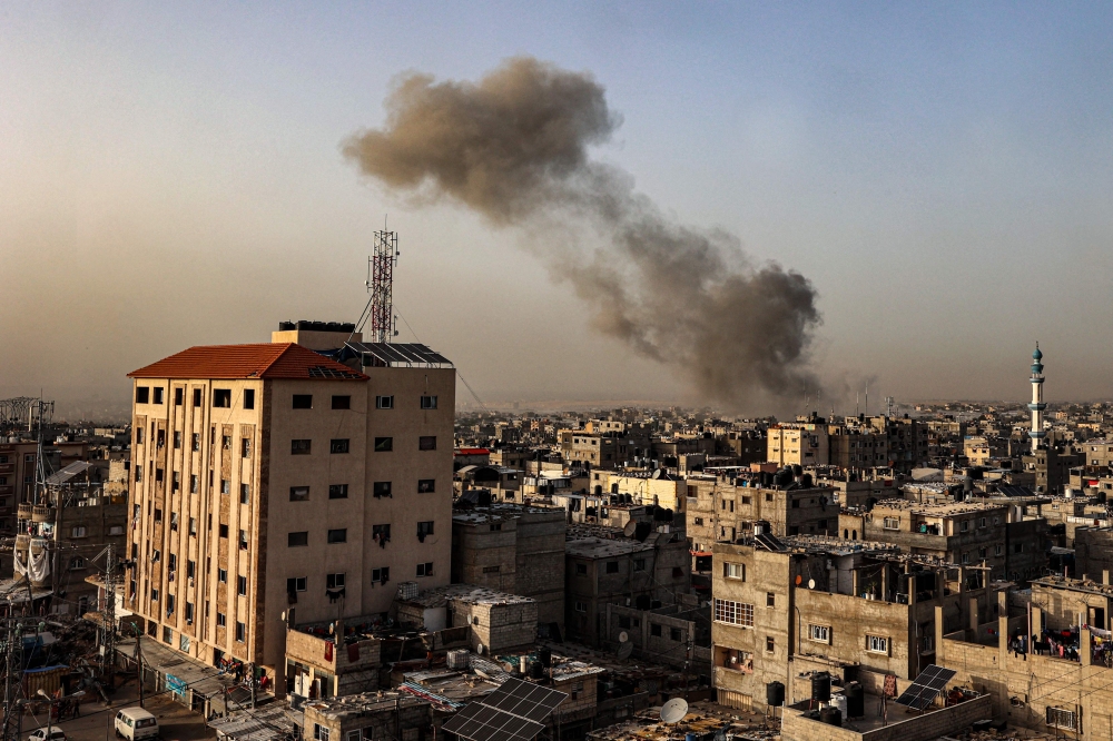 Smoke billows over buildings following Israeli bombardment in Rafah in the southern Gaza Strip on March 27, 2024, amid the ongoing conflict between Israel and the Palestinian militant group Hamas. — AFP pic