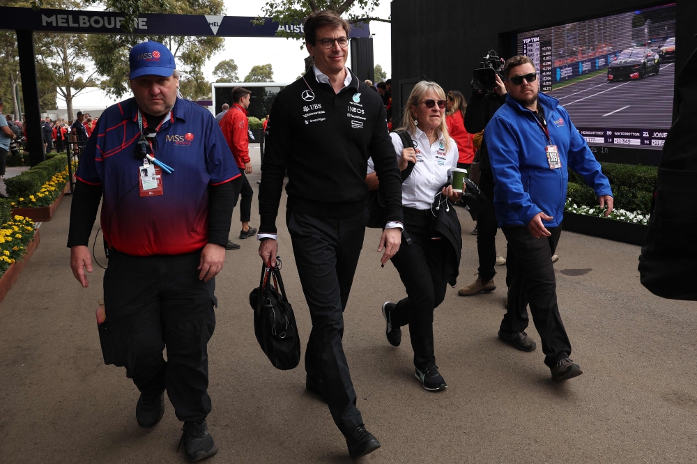 Mercedes F1 CEO and team principal Toto Wolff (2nd L) arrives to the paddock at the Albert Park Circuit ahead of the Formula One Australian Grand Prix in Melbourne on March 24, 2024. — AFP pic