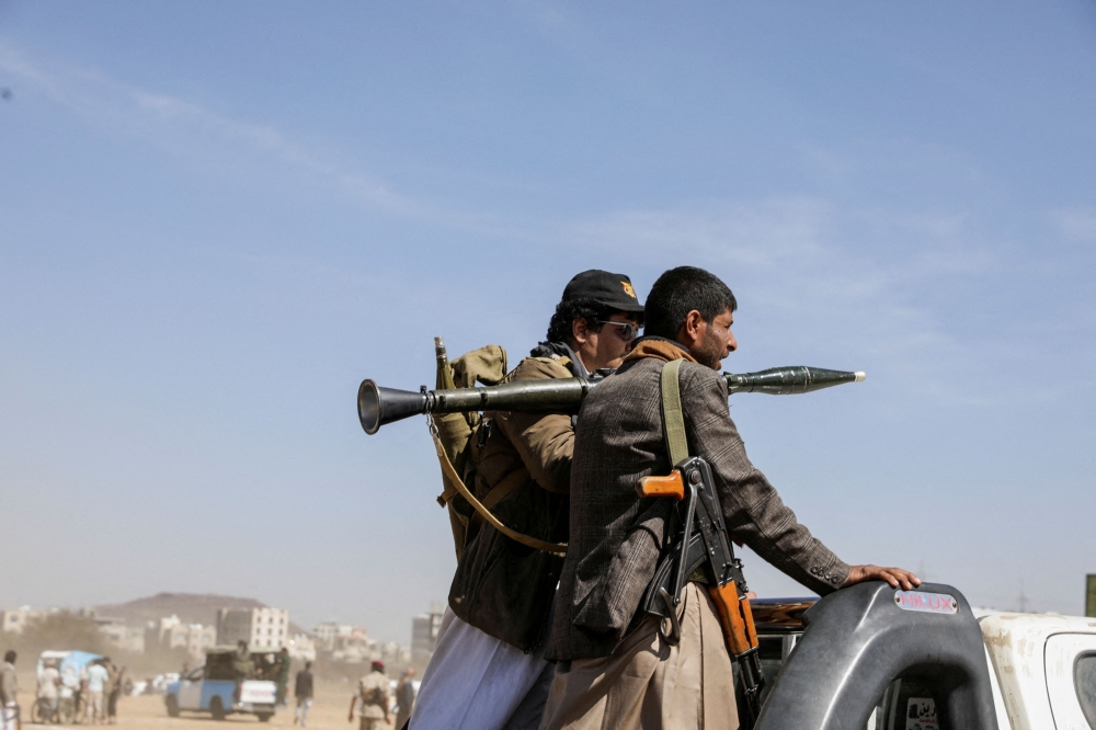 Armed Houthi followers ride on the back of a pick-up truck during a parade in solidarity with the Palestinians in the Gaza Strip and to show support to Houthi strikes on ships in the Red Sea and the Gulf of Aden, in Sanaa, Yemen January 29, 2024. ― Reuters pic