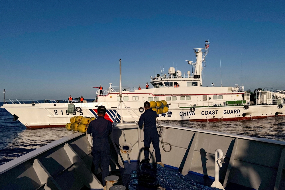 Philippine Coast Guard personnel prepare rubber fenders after Chinese Coast Guard vessels blocked their way to a resupply mission at the Second Thomas Shoal in the South China Sea, March 5, 2024. — Reuters file pic
