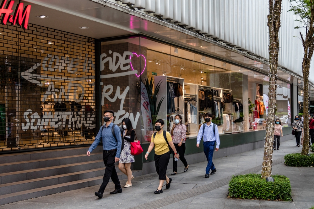 People walk along a street during the morning rush hour in Kuala Lumpur on October 5, 2022. MPC director-general Zahid Ismail said that to date, 2,000 industries or companies have partnered with MPC through the AiI programme, offering job opportunities to 2,600 students nationwide in various sectors. — Picture by Firdaus Latif