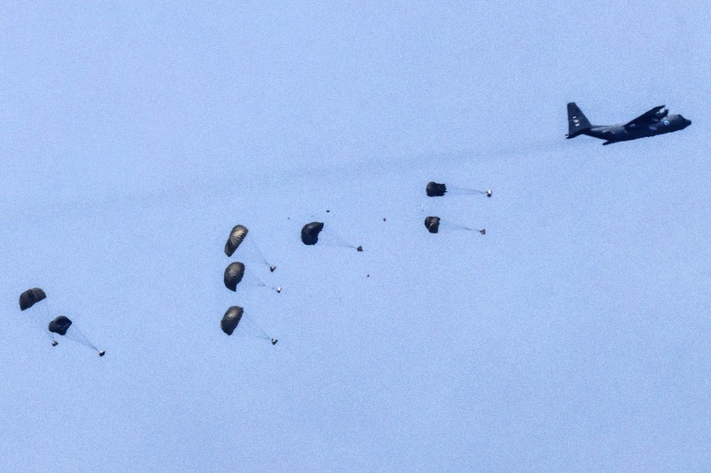 This picture taken from Israel's southern border with the Gaza Strip shows a military aircraft releasing parachutes of humanitarian aid over the besieged Palestinian territory on March 28, 2024, amid the ongoing conflict between Israel and the militant group Hamas. — AFP pic