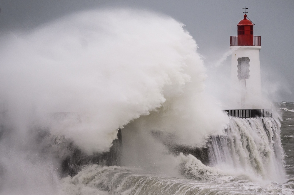 Waves crash against the lighthouse at the entrance to the harbour during Storm Nelson, in Les Sables-d'Olonne, western France, on March 28, 2024. — AFP pic