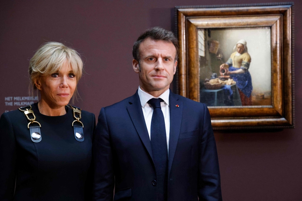 France’s President Emmanuel Macron and his wife, Brigitte Macron, during a visit to the exhibition of Dutch painter Johannes Vermeer at the Rijskmuseum in Amsterdam. — AFP pic