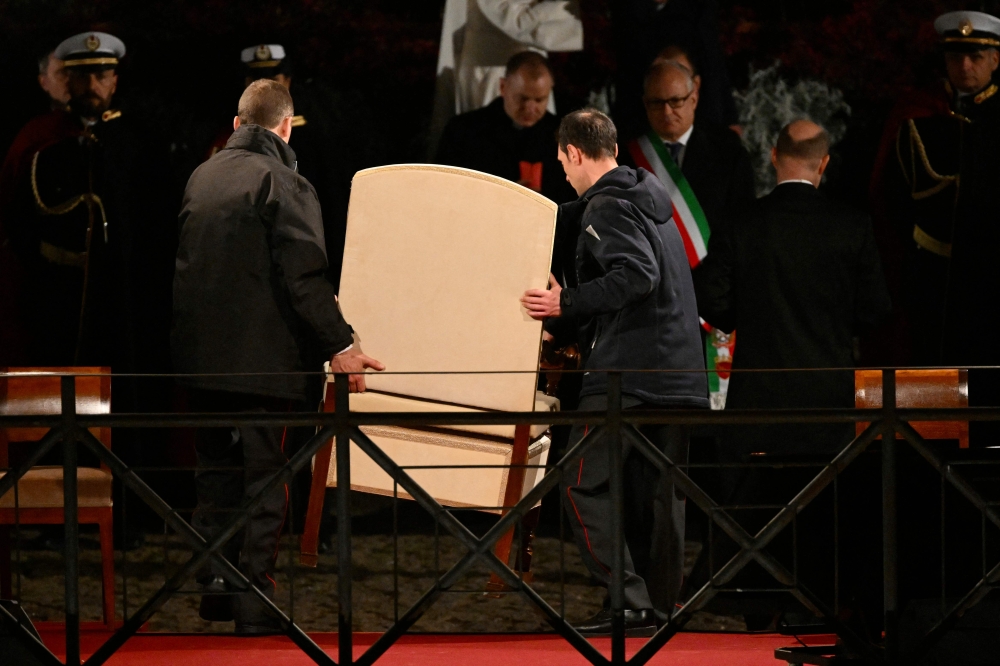 The armchair of Pope Francis is removed after the Vatican announced the Pope will not come to the Colosseum to preside the Way of the Cross (Via Crucis) as part of the Holy Week celebrations in Rome March 29, 2024. — AFP pic