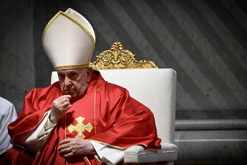 Pope Francis presides the Passion of the Lord mass on Good Friday as part of the Holy Week celebrations, at St Peter's Basilica in the Vatican March 29, 2024. — AFP pic