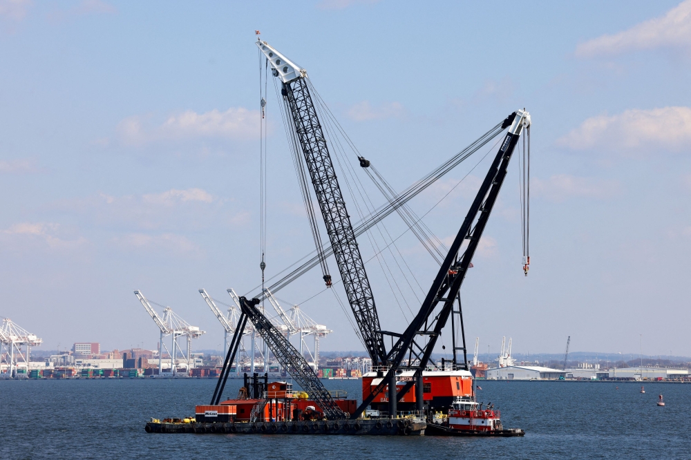 Large cranes in the Patapsco River near the collapsed Francis Scott Key Bridge in Baltimore, Maryland March 29, 2024. — Reuters pic