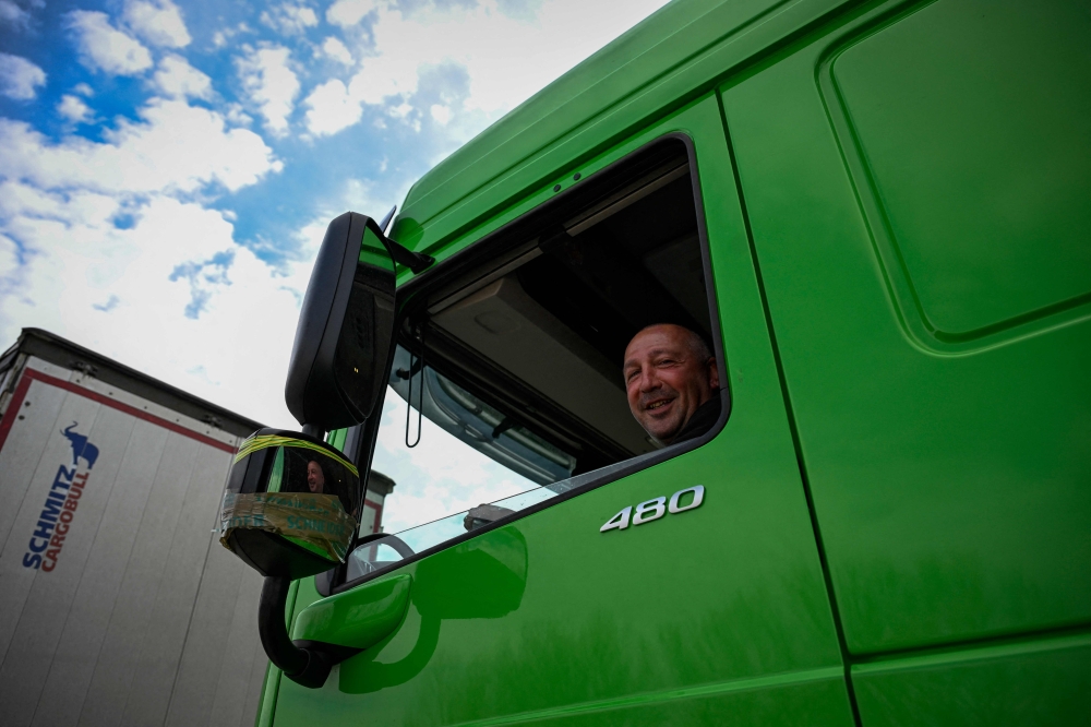 Anton Antonov smiles from the cab of his truck while waiting to enter to the Vidin-Calafat border point between Bulgaria and Romania, near Vidin, Bulgaria on March 24, 2024. — AFP pic