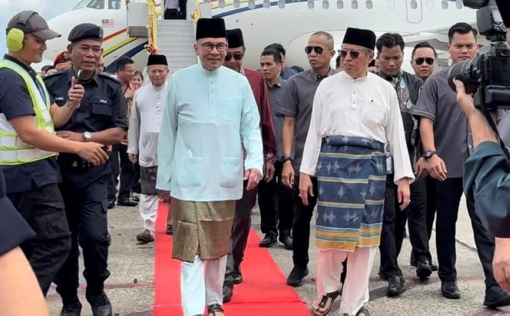 Prime Minister Datuk Seri Anwar Ibrahim (left) being received on arrival by Sarawak Premier Tan Sri abang Johari Openg on arrival at the Kuching International Airport this afternoon, march 30, 2024. — Picture by Sarawak Public Communication Unit (Ukas)